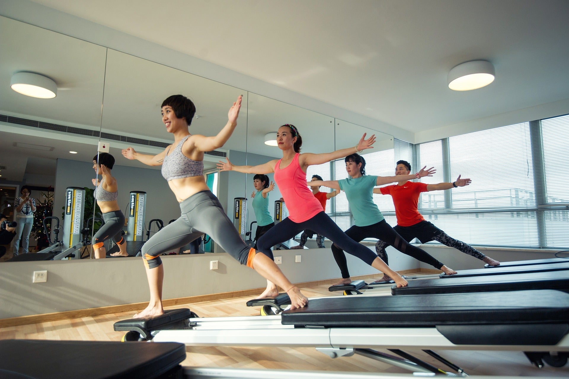 4 people doing pilates for beginners at a private studio.