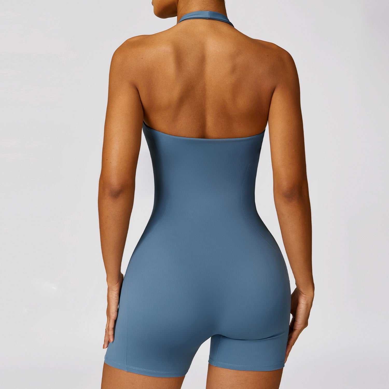 Back view of a sleeveless blue active jumpsuit designed for fitness and comfort.