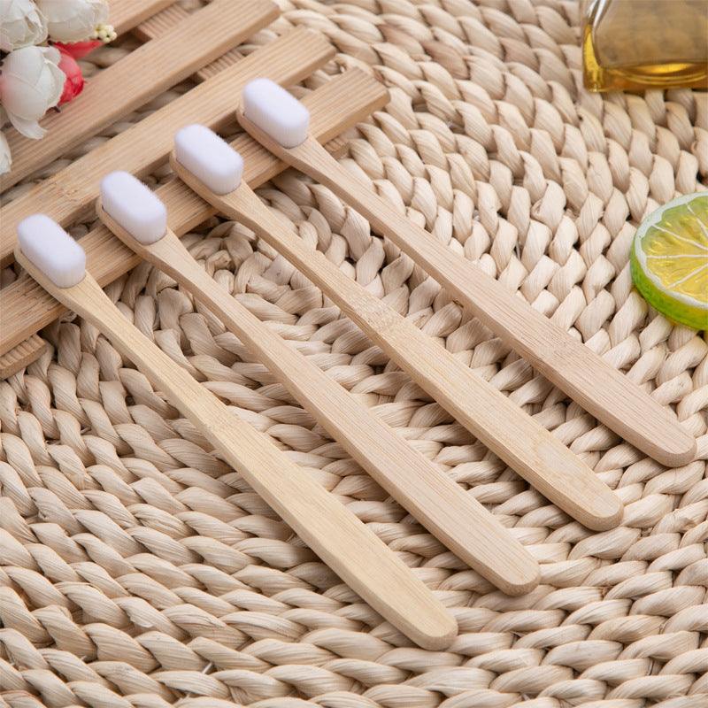 Bamboo toothbrushes with soft bristles on a woven mat, eco-friendly design.