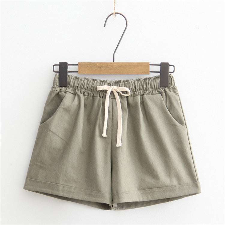 Green comfy shorts with adjustable drawstring waist and pockets, ideal for everyday wear.