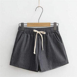 Comfortable gray shorts with adjustable drawstring waist and pockets hanging on a hanger.