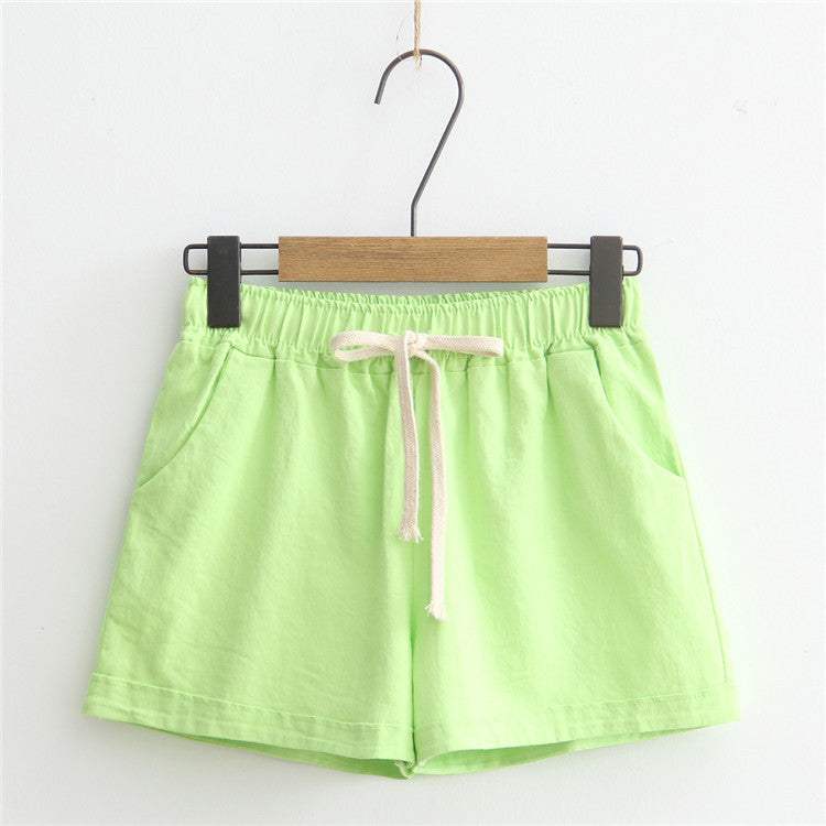 Light green comfy shorts with adjustable drawstring waist and pockets, perfect for everyday wear.