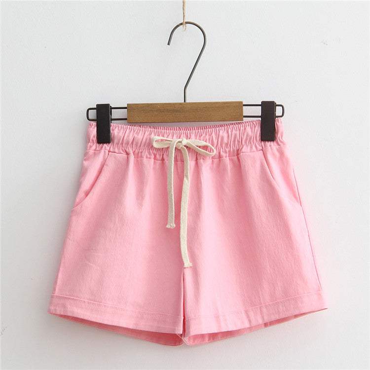 Pink comfy shorts with adjustable drawstring waist and breathable cotton fabric.