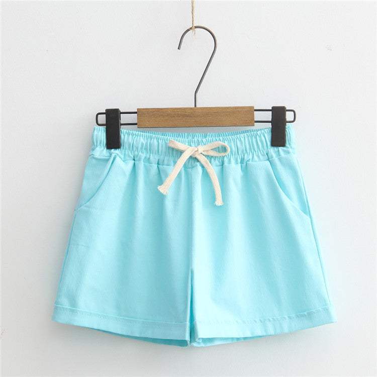 Light blue comfy shorts with adjustable drawstring waist and pockets, made from breathable cotton.