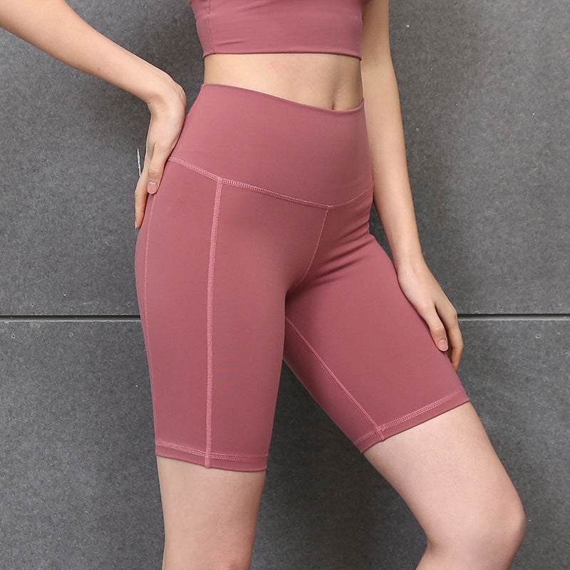 High-waisted pink yoga shorts for women, providing comfort and style.