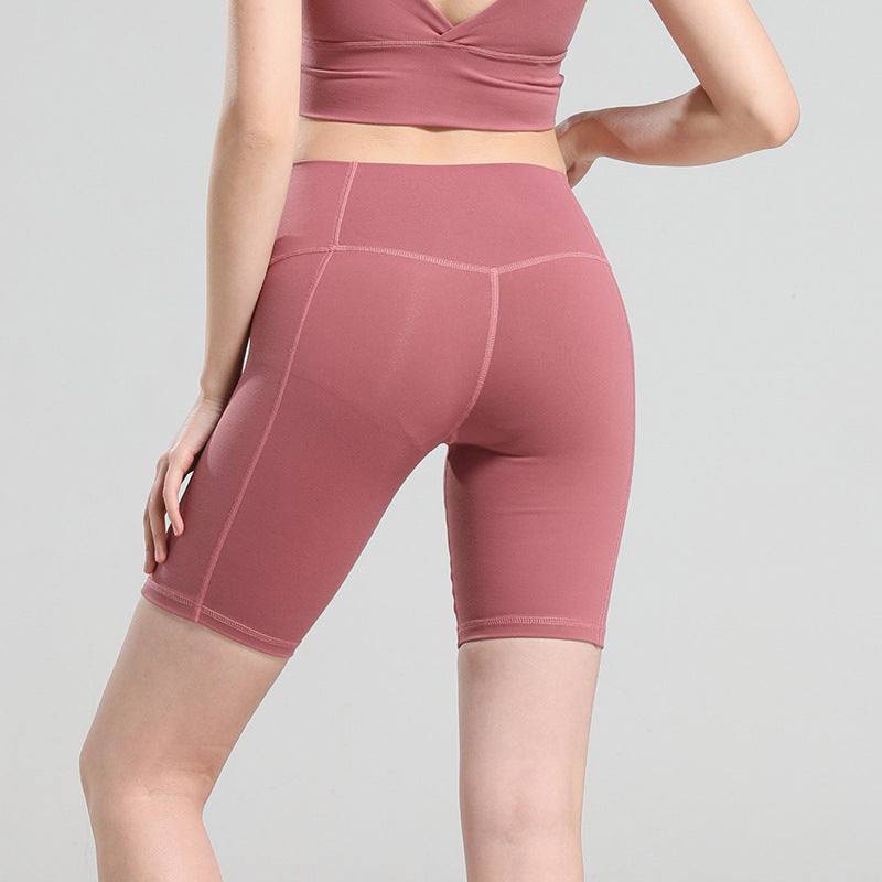 Back view of pink comfy yoga shorts offering a snug fit and full range of motion.