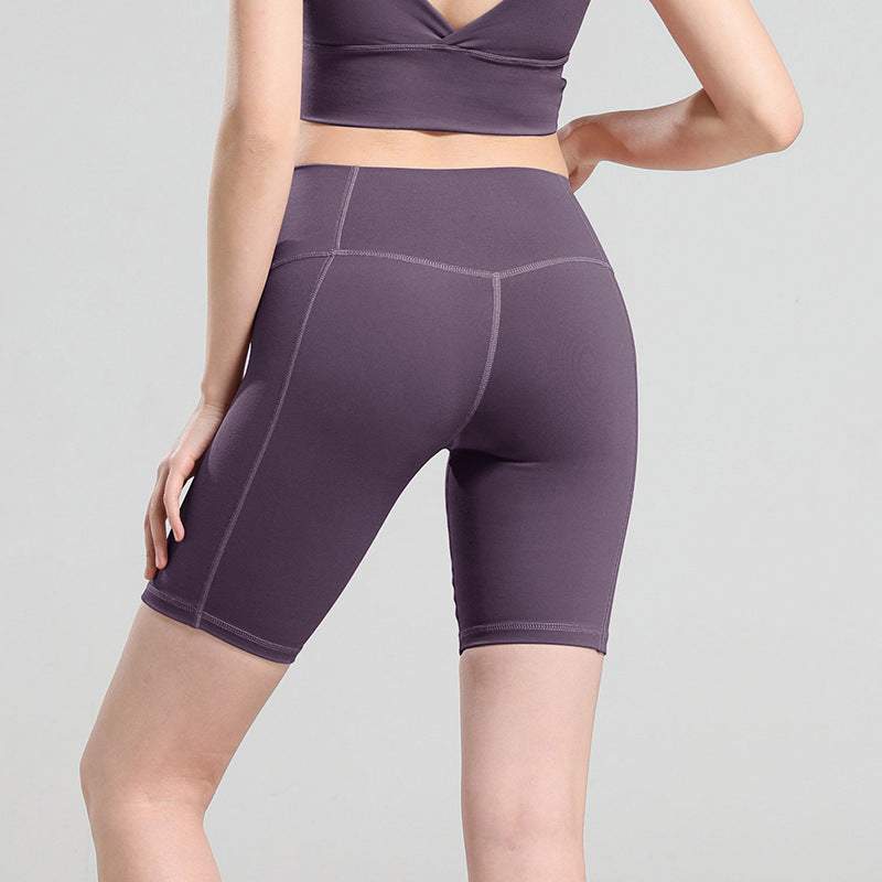 Comfortable yoga shorts in soft cotton, shown in purple, offering flexibility and support. Ideal for workouts and casual wear.