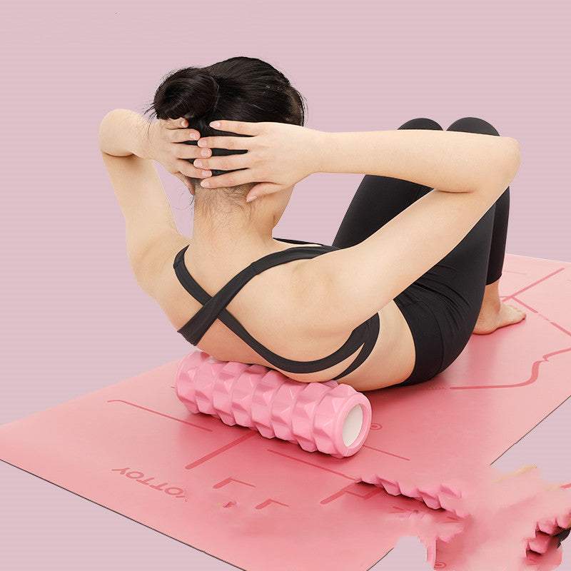 Person using the Enhanced Fitness Roller on a pink mat for muscle recovery and deep tissue massage.