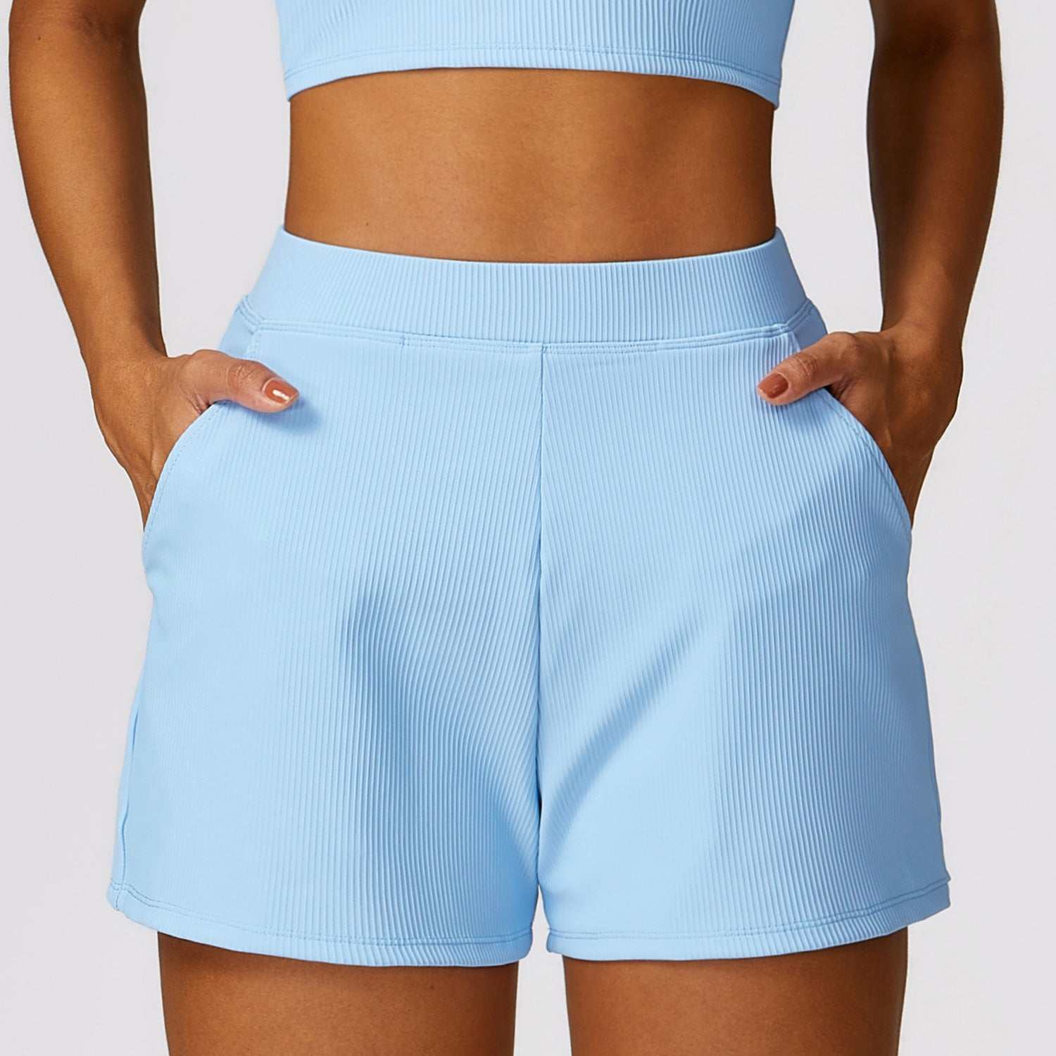 Light blue high waist shorts made of breathable nylon with convenient pockets, perfect for active lifestyles.