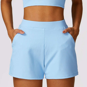 Light blue high waist shorts made of breathable nylon with convenient pockets, perfect for active lifestyles.