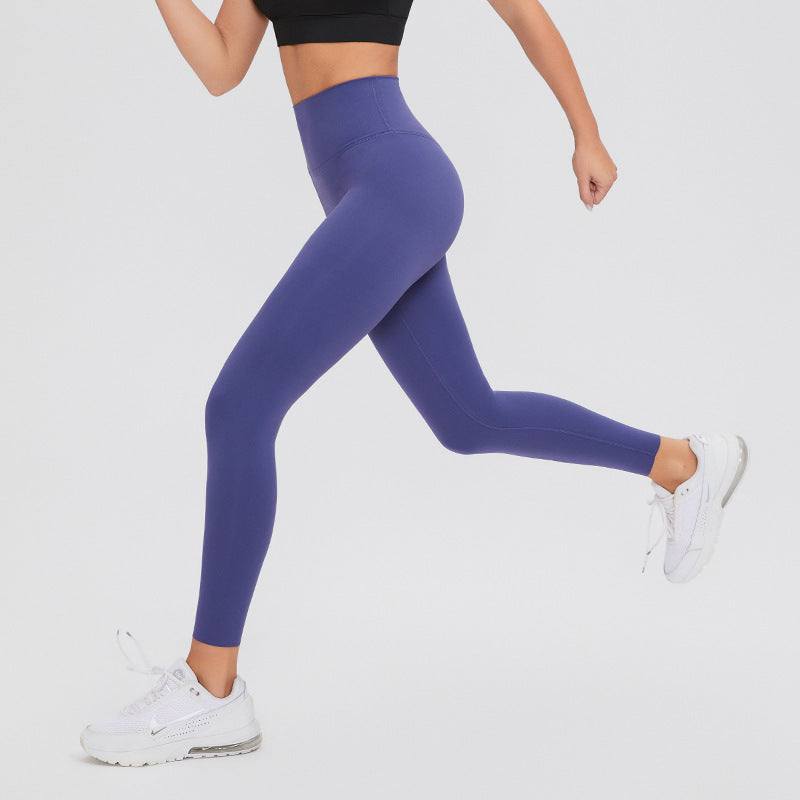 High-waist leggings in vibrant purple providing comfort and functionality during a workout.