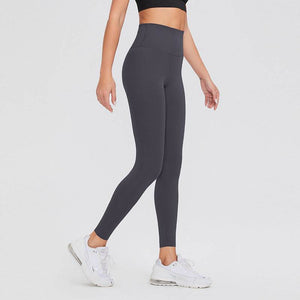 Woman wearing black high waist leggings and white sneakers.