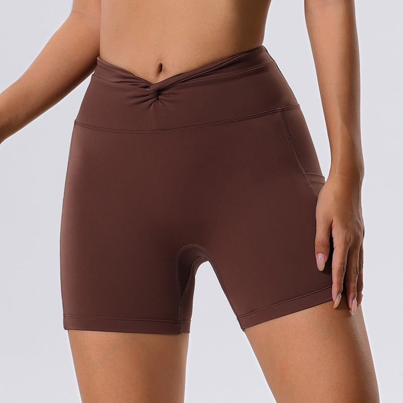 Brown high waist yoga shorts with quick-drying fabric and pocket.