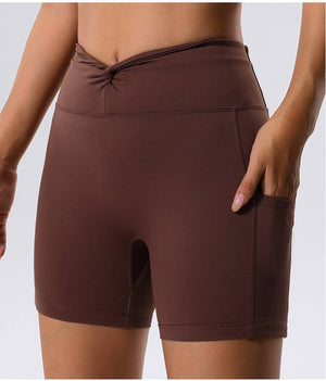 Brown high waist yoga shorts with sleek design and side pocket.