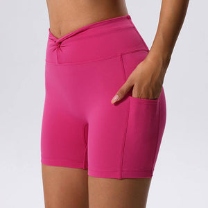 Pink high waist yoga shorts with pocket, quick-drying fabric, and butt-lifting design.