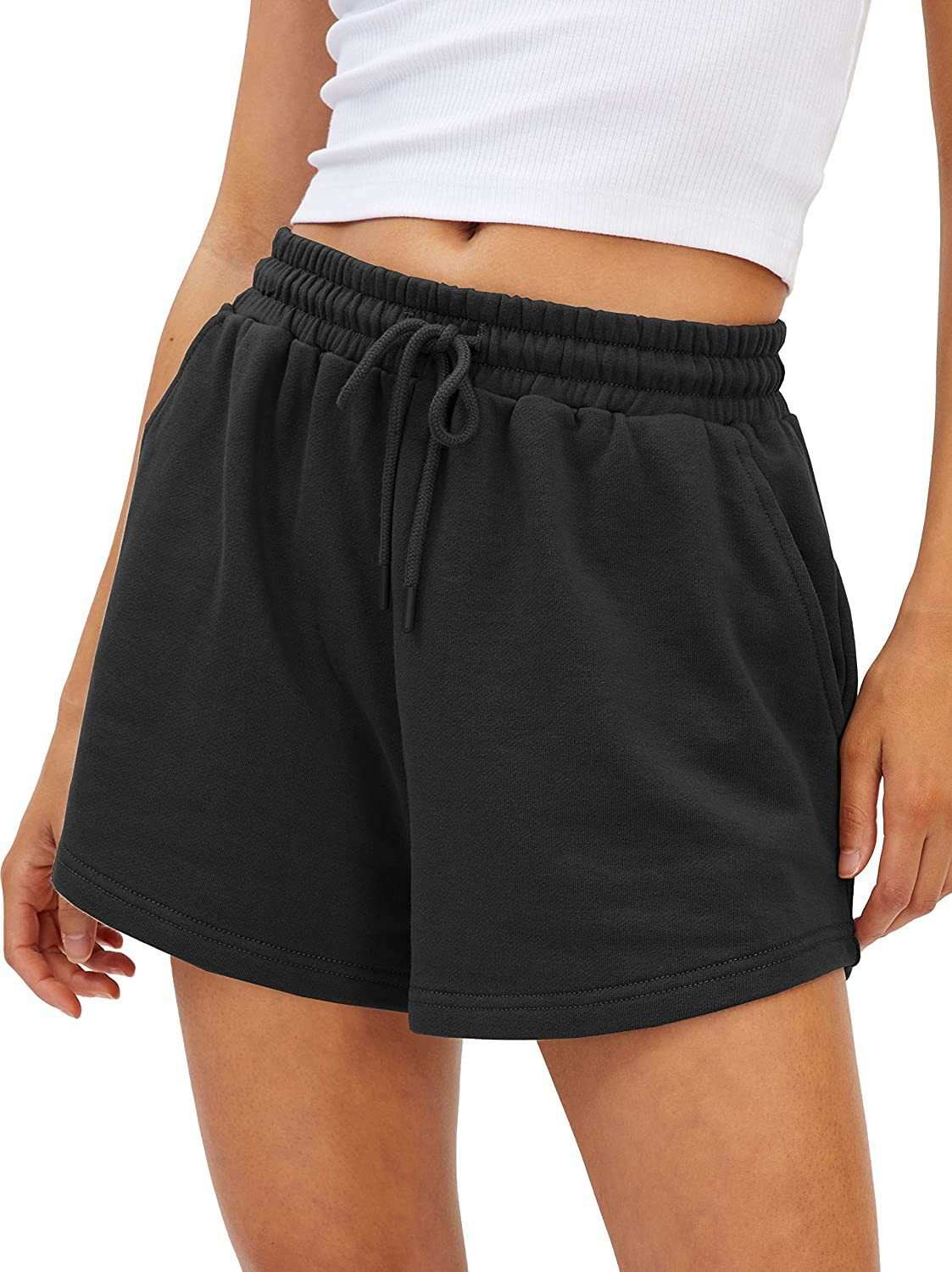 Women's black loose fit shorts with adjustable drawstring waist, shown on model.