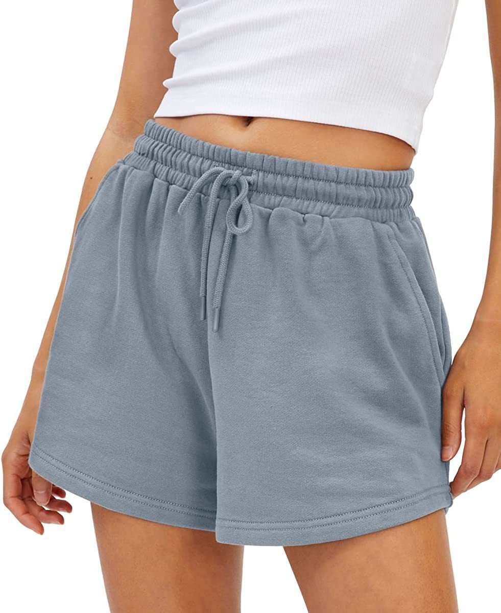 Loose fit shorts in light blue with adjustable drawstring and pockets, made from quick-drying polyester for active comfort.