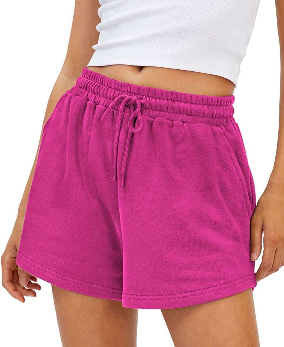 Women's pink loose fit shorts with drawstring waist and breathable fabric.