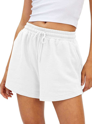 Loose fit white shorts with drawstring waist and pockets, perfect for active lifestyle.