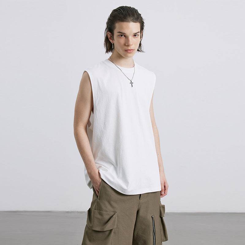 Loose fit tank top in white with breathable fabric, modeled with cargo pants.