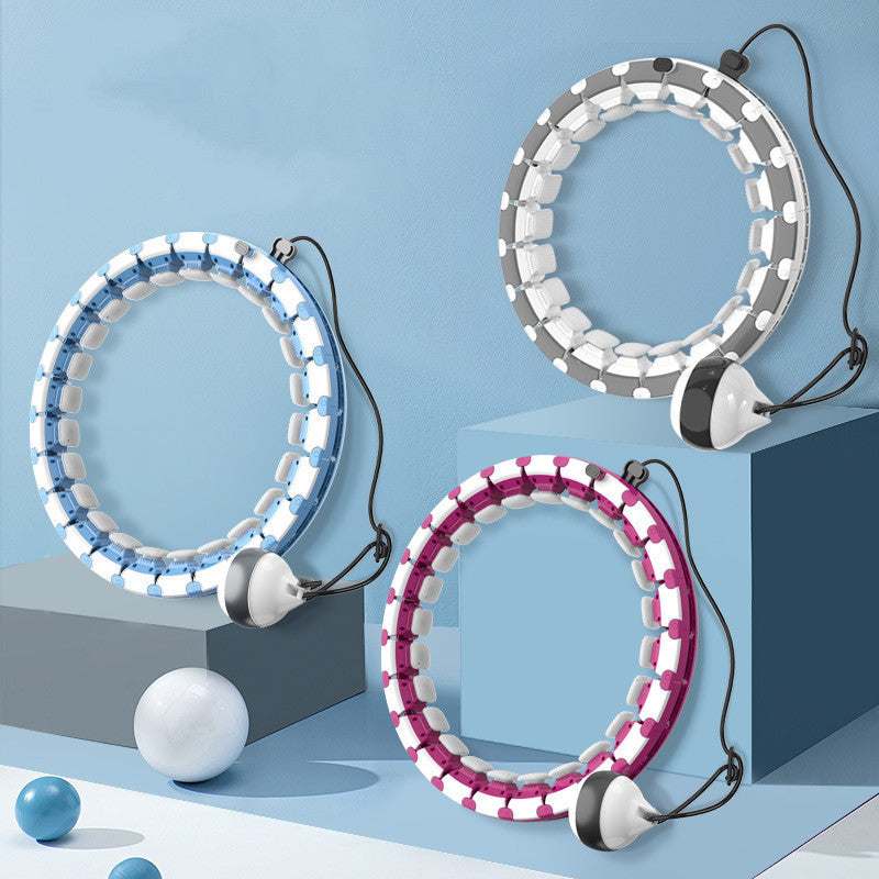 Modern exercise hoop with adjustable weight ball in blue, gray, and red on display.