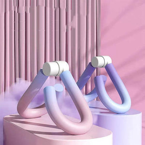 Colorful Muscle Trainer exercise equipment displayed on platforms against a pink background.