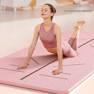 Woman practicing yoga on a pink non-slip, wide yoga mat with alignment guides, 70cm wide.