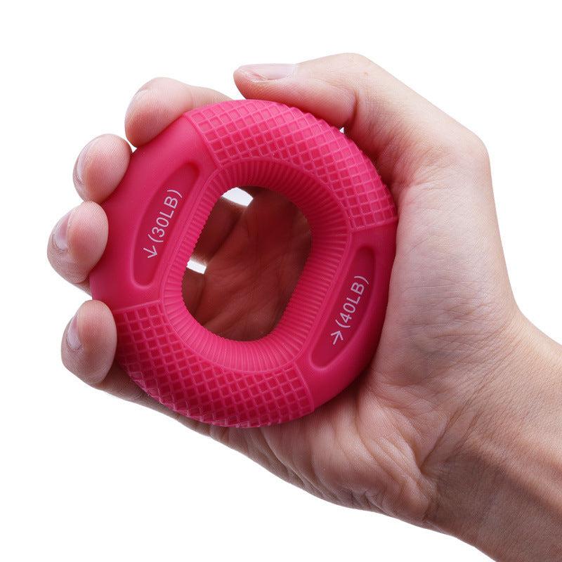 Silicone Grip Ring in hand, pink color, for hand strength training, 20-30lbs resistance.