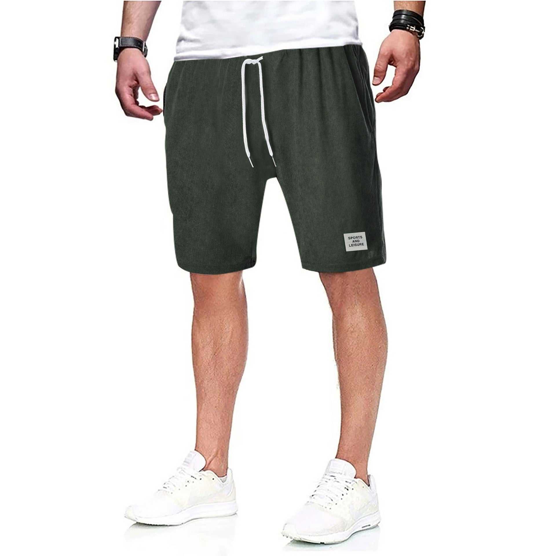 Man wearing charcoal gray drawstring shorts with white sneakers.