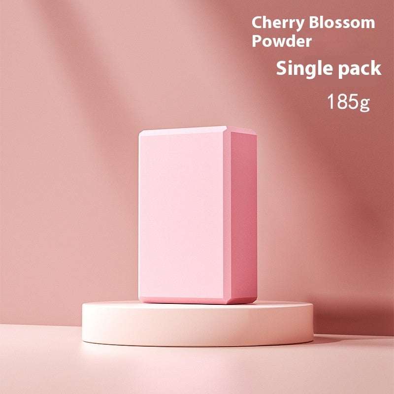 Pink Simple Yoga Block on a podium against a pink background, labeled Cherry Blossom Powder, Single Pack, 185g.