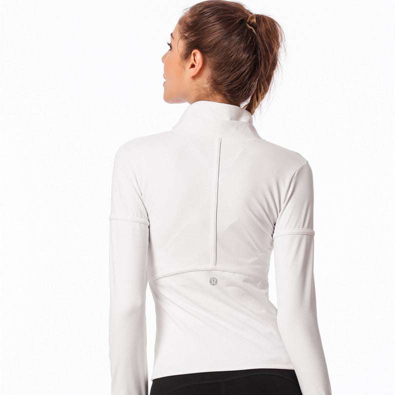 Woman wearing a white snug fit jacket, showcasing sleek and comfortable design.