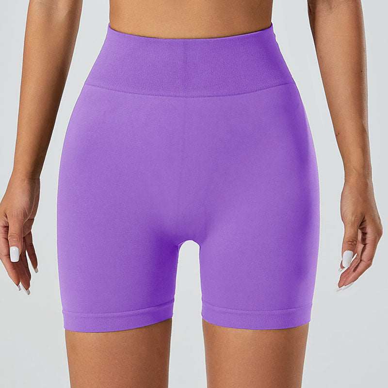 Purple snug fit yoga shorts with high-waist design.