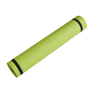 Green non-slip yoga mat with honeycomb design, rolled and ready for exercise.