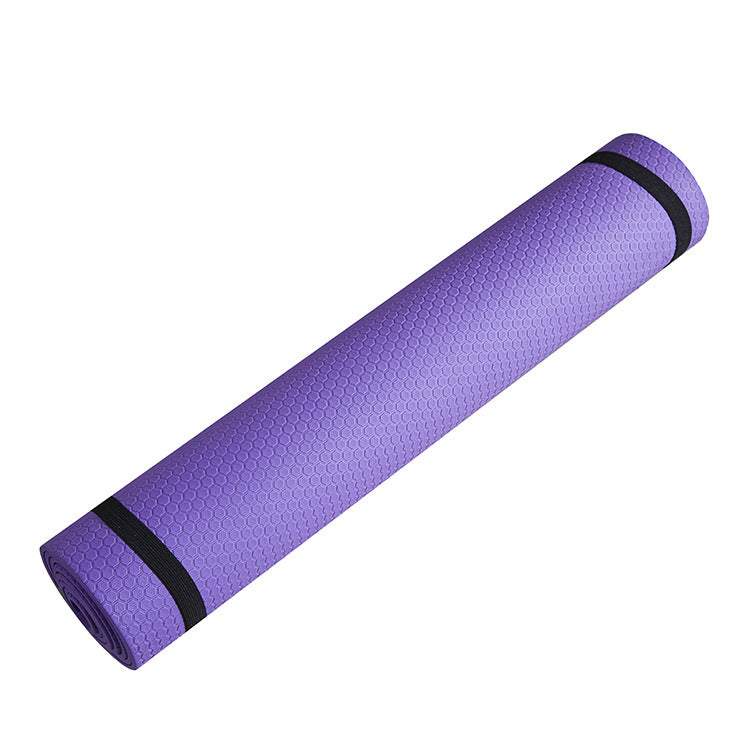 Purple yoga mat with non-slip honeycomb design, rolled up.